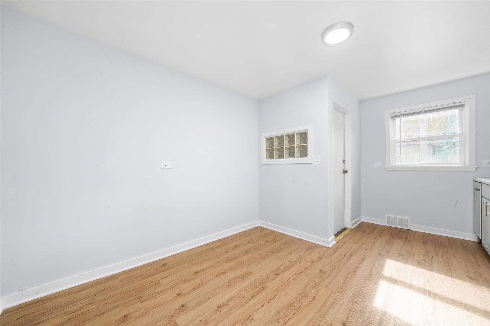 420 Prospect Boulevard, Unit 1N Elgin, IL 60120 - Photo 16 of 16 an empty room with wooden floor and windows