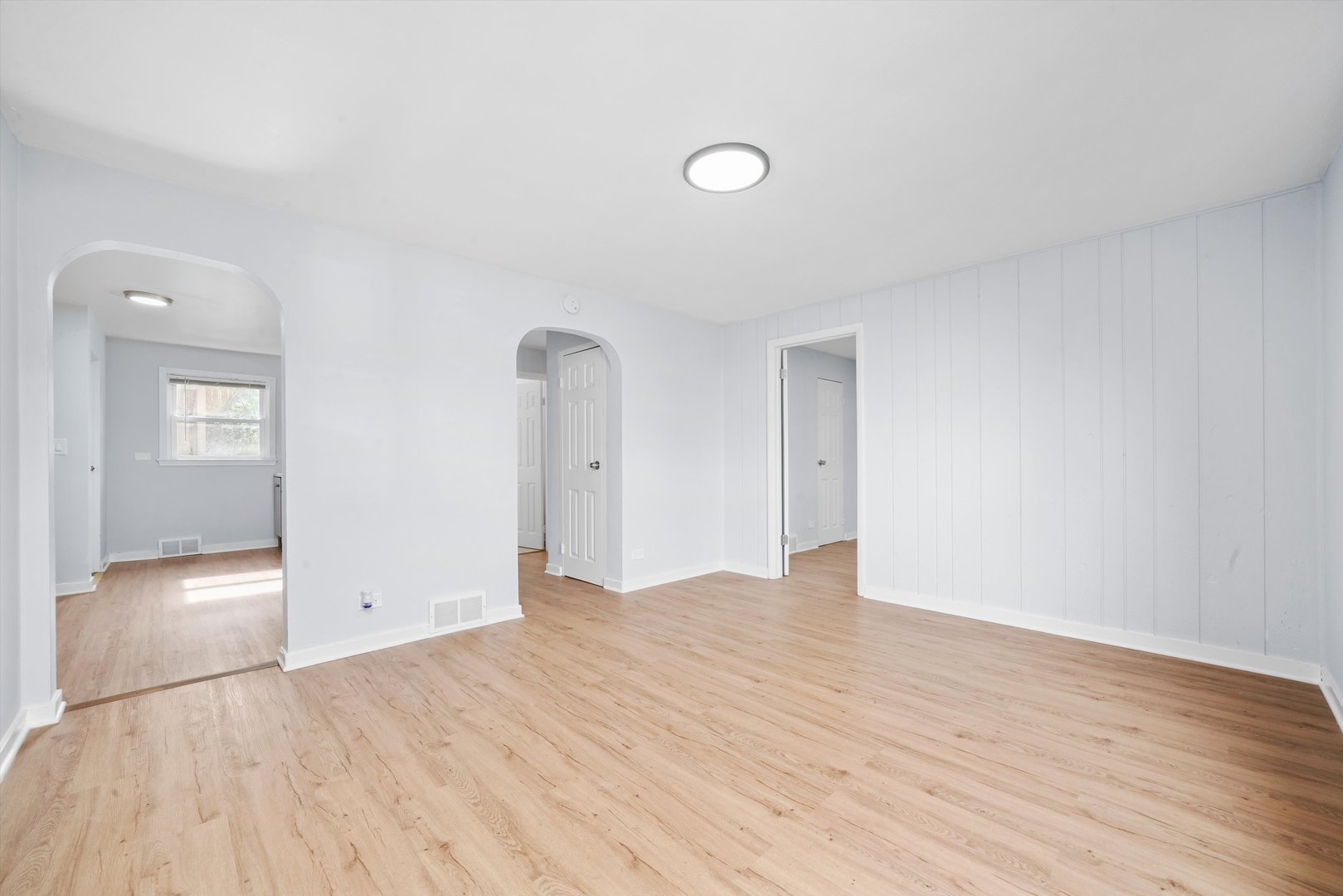 420 Prospect Boulevard, Unit 1N Elgin, IL 60120 - Photo 4 of 16 a view of an empty room with wooden floor and a bathroom