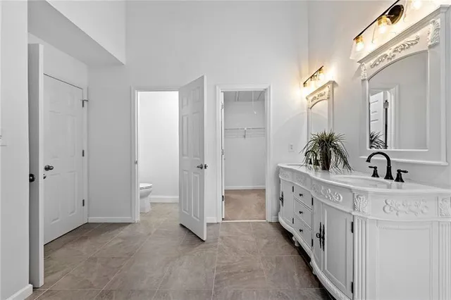 a bathroom with double vanity sink and mirror
