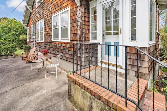 a balcony with table and chairs
