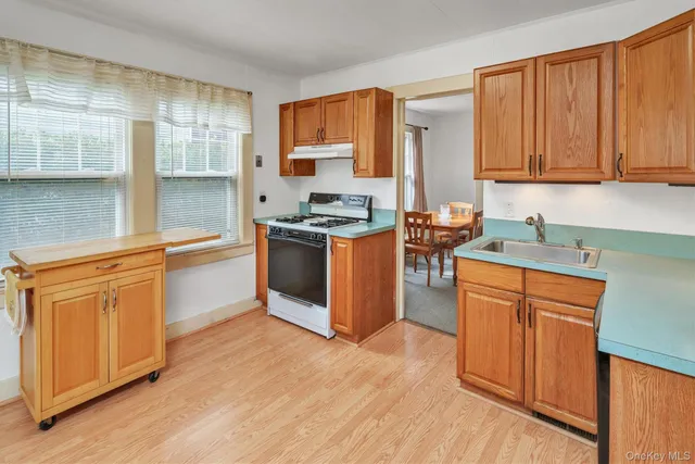 a kitchen with stainless steel appliances granite countertop a stove a sink dishwasher and a refrigerator
