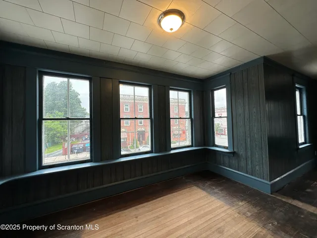 a room with a chair and white walls