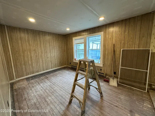 a bathroom with a sink and mirror with bathtub