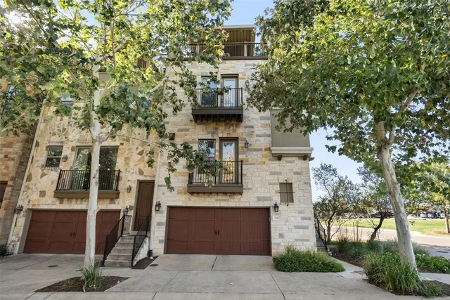 a front view of a building with trees
