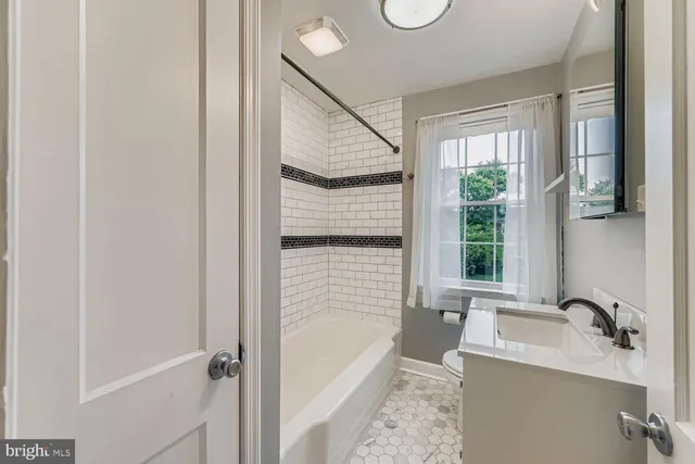 a bathroom with a sink a bathtub and shower