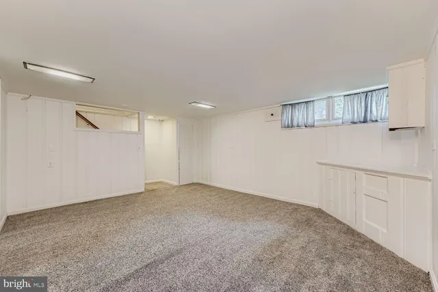 a view of an empty room with a kitchen