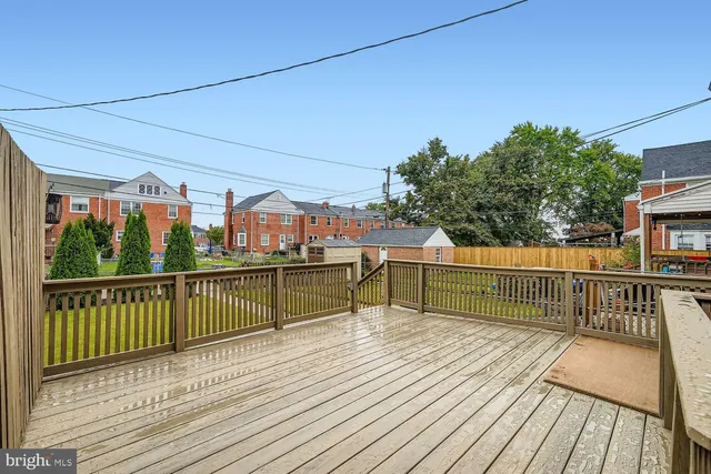 a view of balcony with wooden floor and fence
