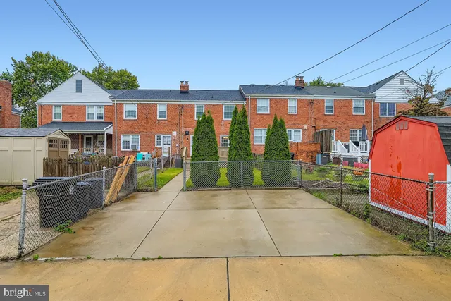 a view of a brick house with a swimming pool