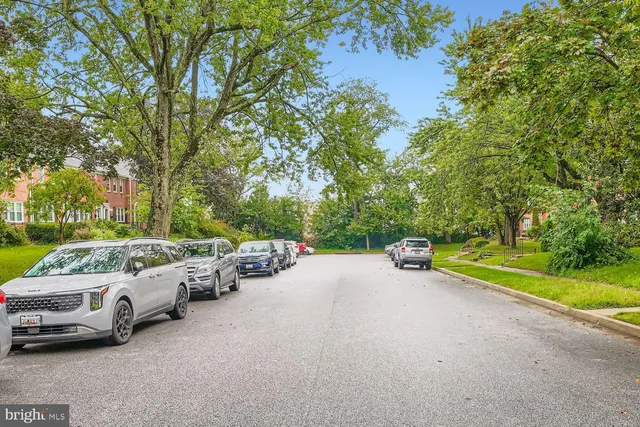a view of a street with cars parked