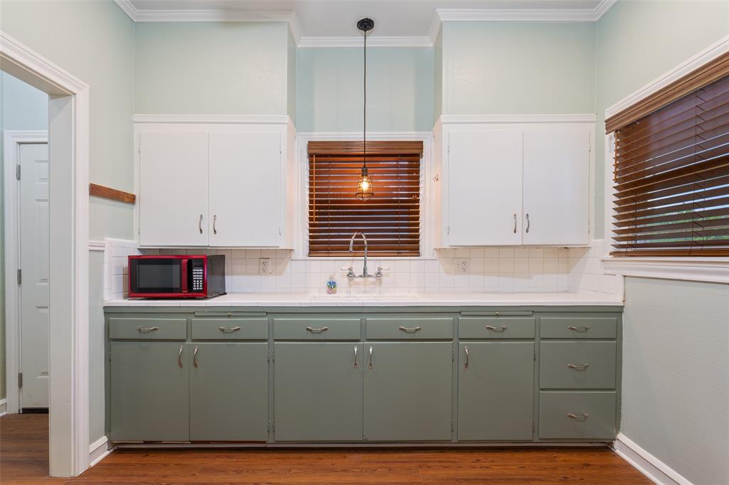 2600 Maple Avenue Waco, TX 76707 - Photo 13 of 28 a kitchen with a sink cabinets and window