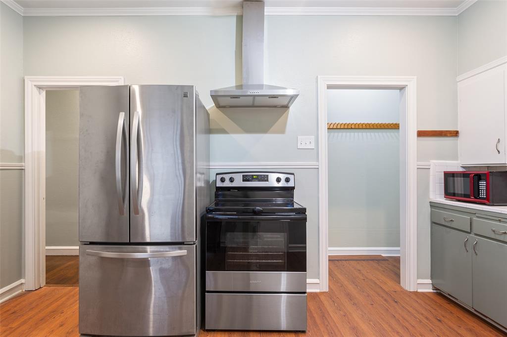 2600 Maple Avenue Waco, TX 76707 - Photo 14 of 28 a kitchen with a refrigerator and a stove top oven