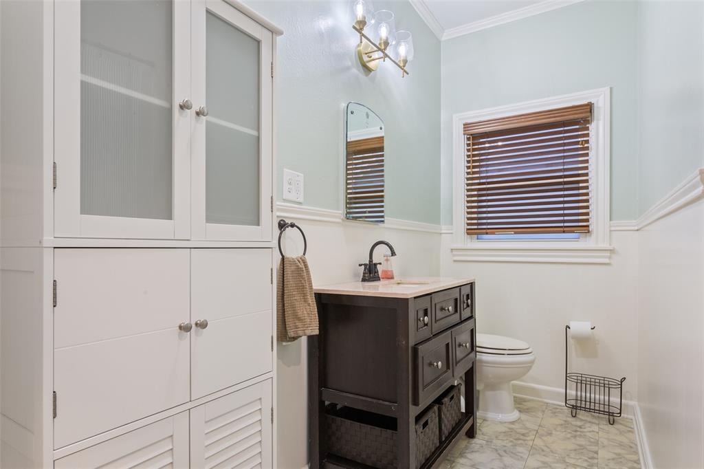 2600 Maple Avenue Waco, TX 76707 - Photo 17 of 28 a bathroom with a sink a toilet and mirror