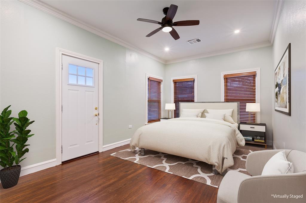 2600 Maple Avenue Waco, TX 76707 - Photo 23 of 28 a bedroom with a large bed chandelier and a window