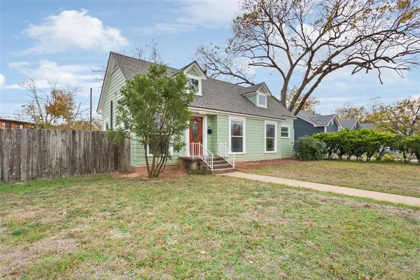 a house that has a tree in front of it