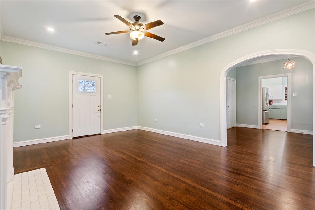 2600 Maple Avenue Waco, TX 76707 - Photo 6 of 28 an empty room with wooden floor and a hallway