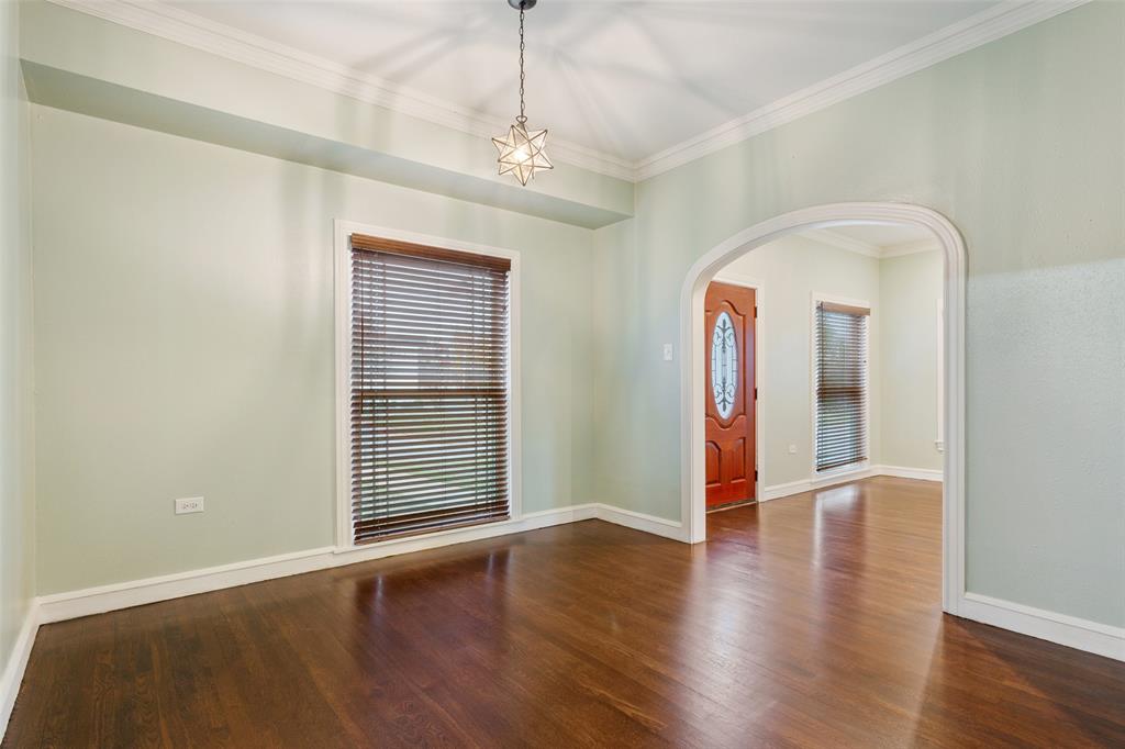 2600 Maple Avenue Waco, TX 76707 - Photo 10 of 28 an empty room with wooden floor chandelier and windows