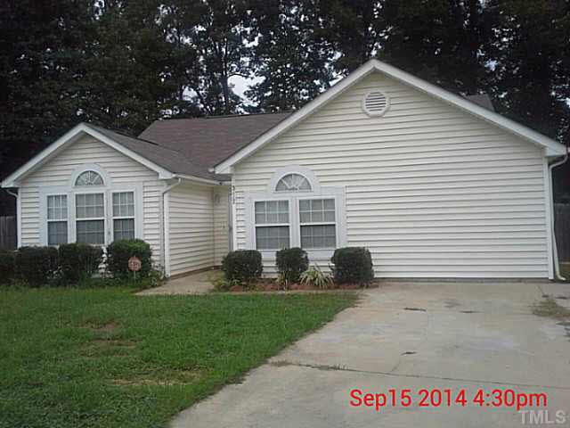 3117 Mango Drive Raleigh, NC 27610 - Photo 1 of 6 a front view of a house with a yard and garage