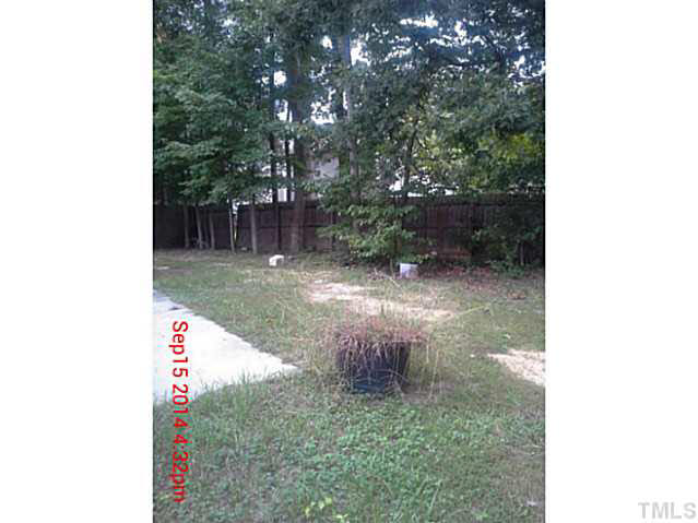 3117 Mango Drive Raleigh, NC 27610 - Photo 3 of 6 a backyard of a house with lots of green space