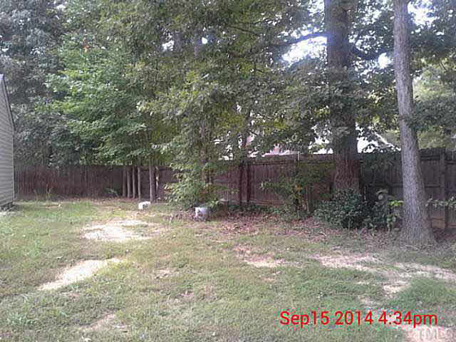 3117 Mango Drive Raleigh, NC 27610 - Photo 5 of 6 a backyard of a house with lots of green space