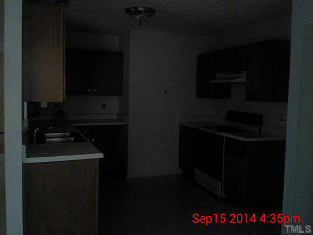 3117 Mango Drive Raleigh, NC 27610 - Photo 6 of 6 a kitchen with a stove and a microwave