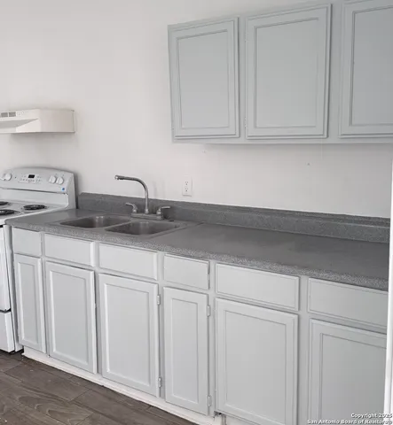 a kitchen with white cabinets