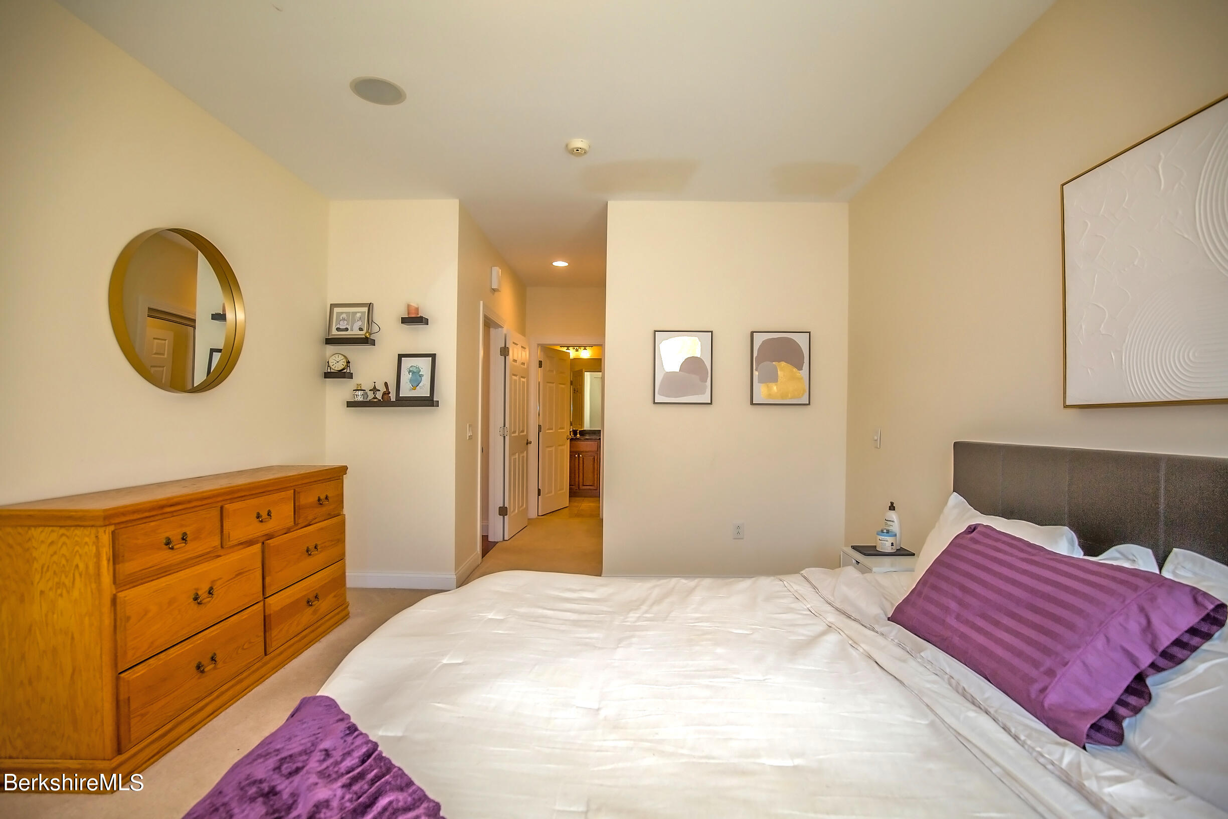 77 Alpine Trail Pittsfield, MA 01201 - Photo 20 of 58 a bedroom with a large bed and a chandelier