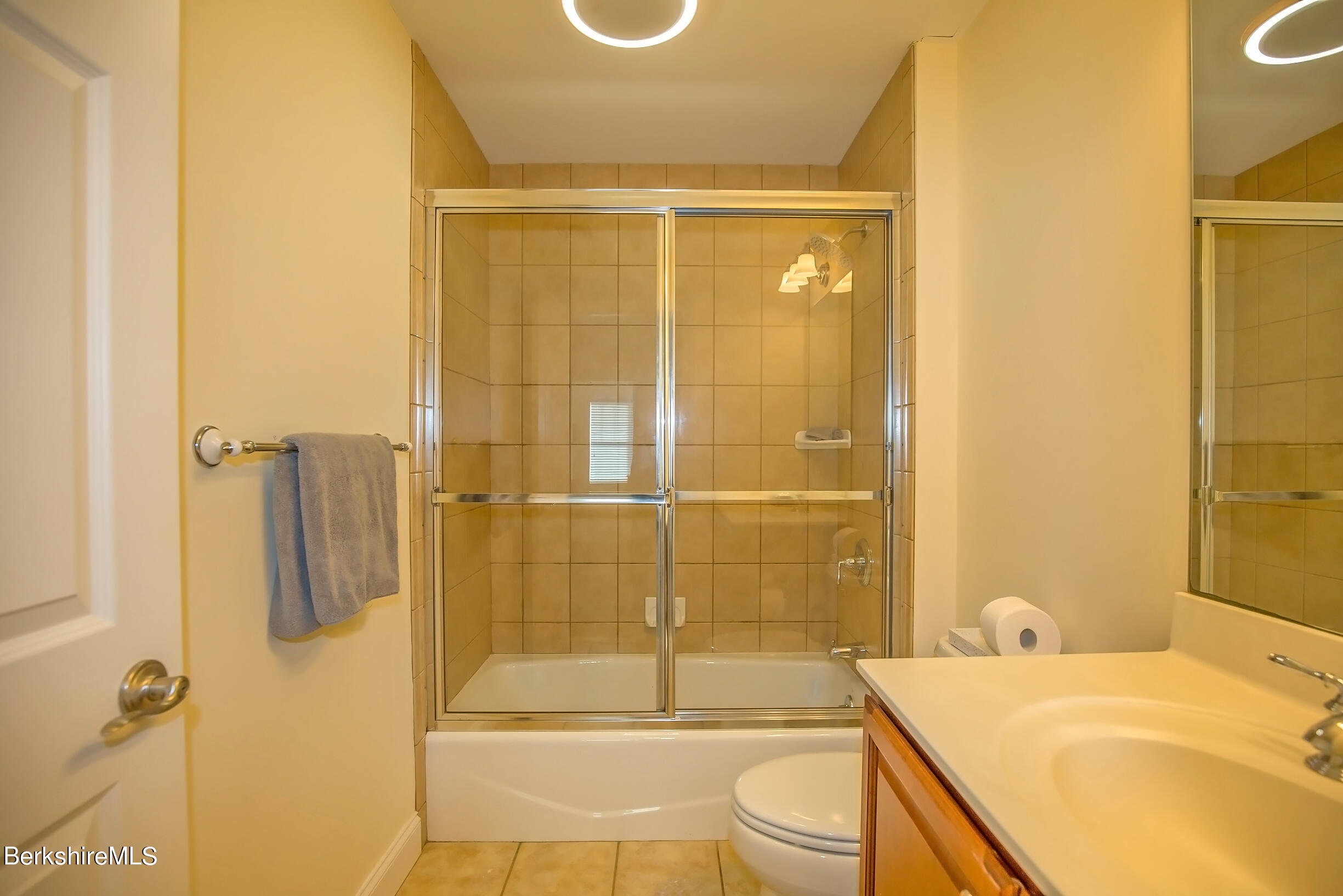 77 Alpine Trail Pittsfield, MA 01201 - Photo 26 of 58 a bathroom with a sink and mirror with bathtub