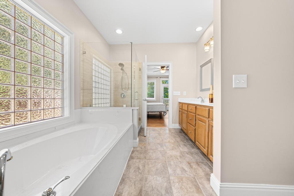 217 Maret Road Townville, SC 29689 - Photo 18 of 35 Indulge in a primary bathroom featuring a spacious soaking tub and a clear glass shower enclosure.
