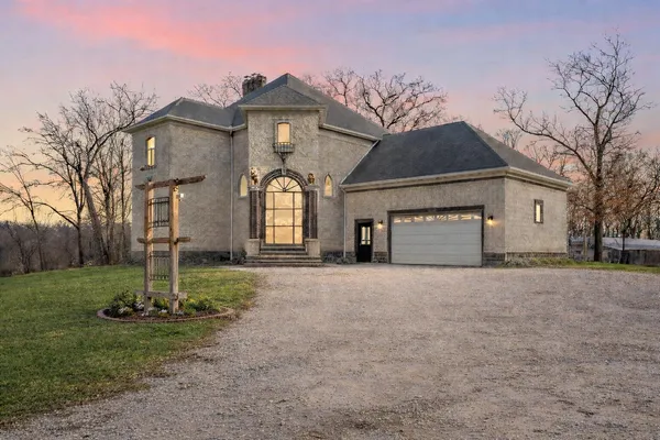a front view of a house with a yard and garage