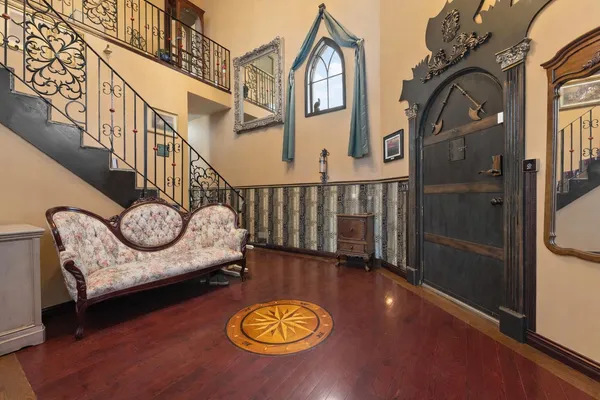 a view of a livingroom with furniture and staircase with wooden floor
