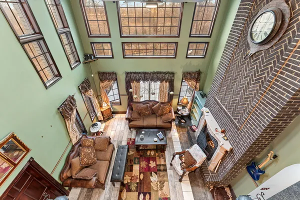 a living room with fireplace furniture and a large window
