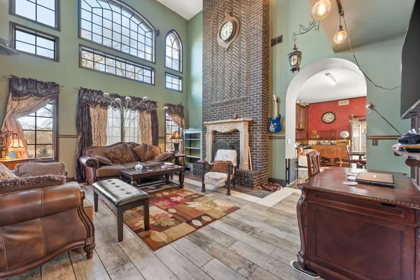 a living room with furniture fireplace and a table