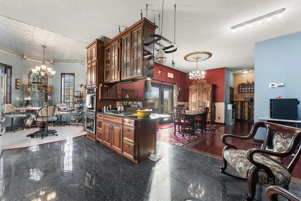 a kitchen with stainless steel appliances granite countertop a stove and cabinets