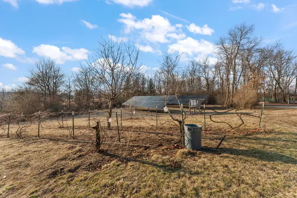 a view of backyard with wooden fence