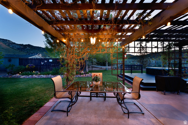 7343 North Sawtooth Cv Road Vernal, UT 84078 - Photo 36 of 64 Expansive outdoor living area featuring a wooden pergola with string lights, a concrete patio, and a separate elevated deck