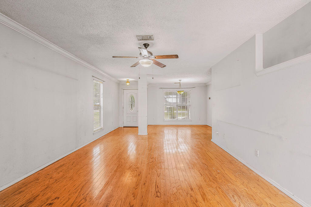53 4th Street Shalimar, FL 32579 - Photo 6 of 47 wooden floor in an empty room with a window
