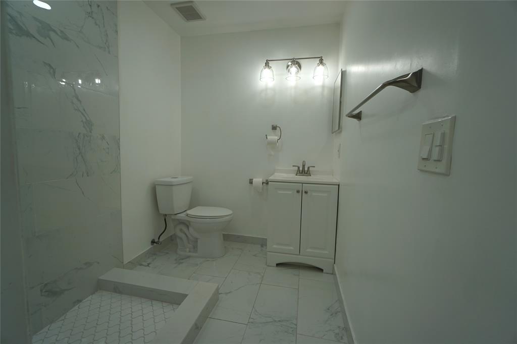 6380 West 24th Court Hialeah, FL 33016 - Photo 14 of 41 a bathroom with a toilet a sink and mirror