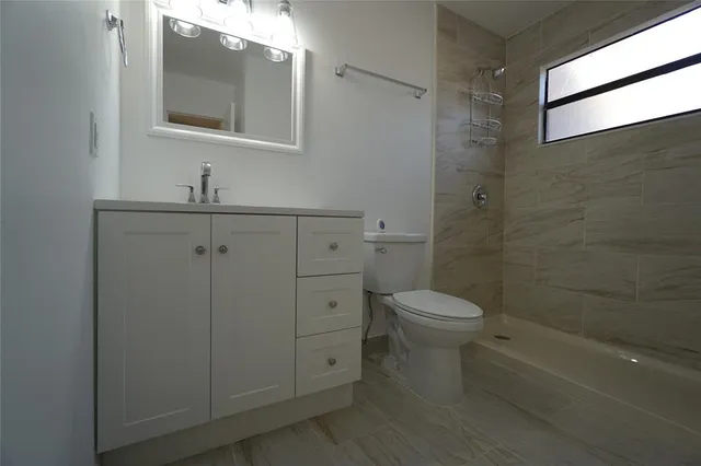 a bathroom with a toilet and shower