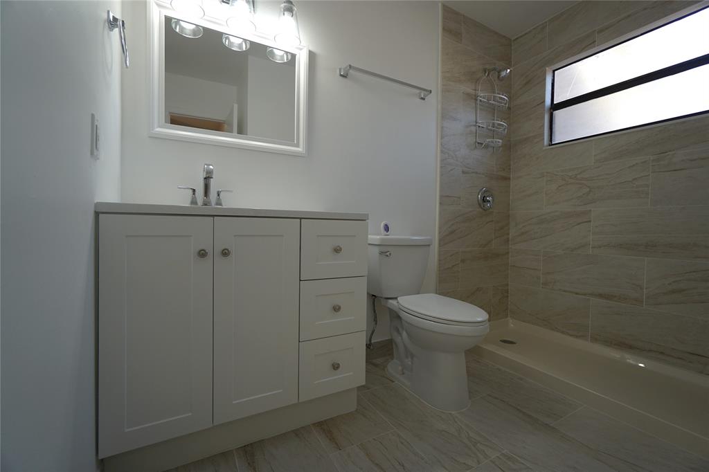 6380 West 24th Court Hialeah, FL 33016 - Photo 29 of 41 a bathroom with a toilet a sink a mirror and vanity