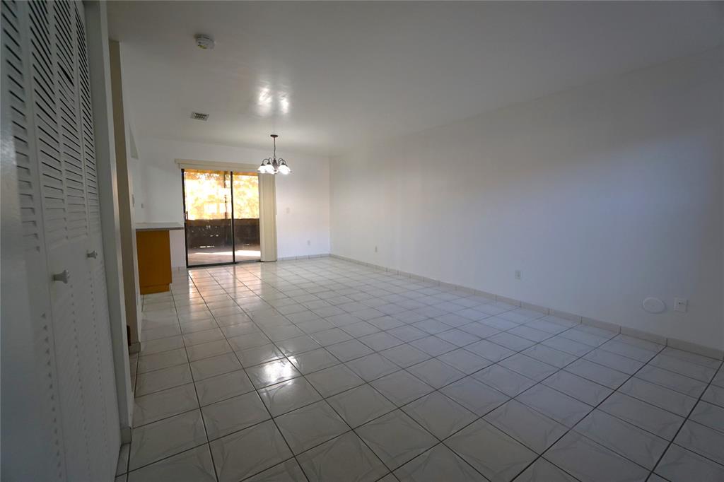 6380 West 24th Court Hialeah, FL 33016 - Photo 4 of 41 an empty room with windows and entrance