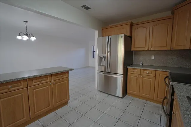 a kitchen with cabinets and stainless steel appliances