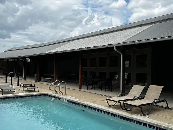 a building outdoor space with patio furniture and garden