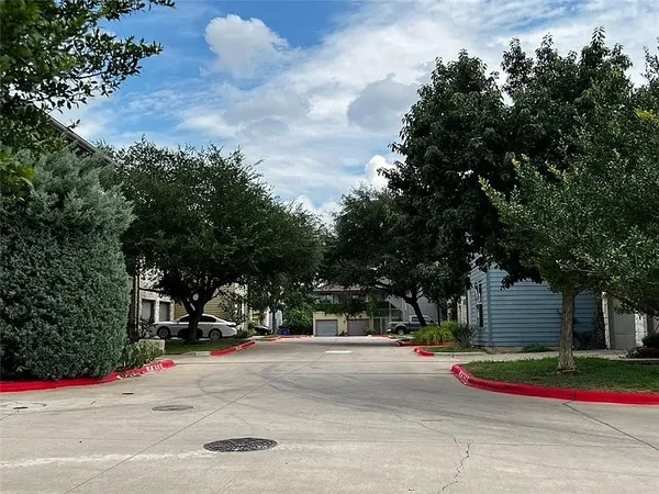 a view of a street with benches