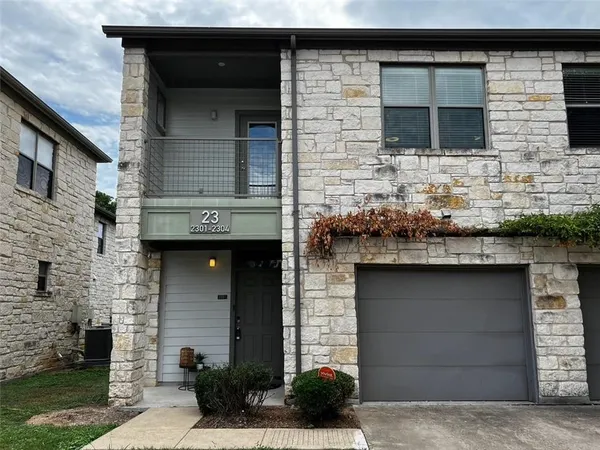 a brick house with a sink and a yard