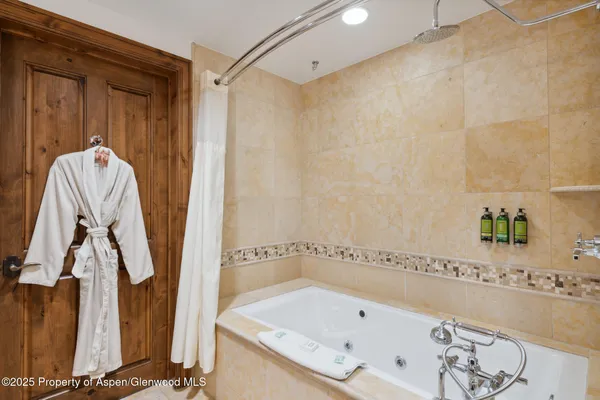 a bathroom with a tub and a shower
