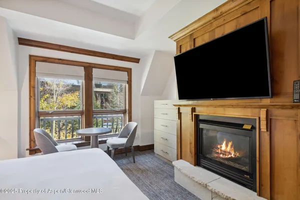 a living room with a fireplace a flat screen tv and a fireplace