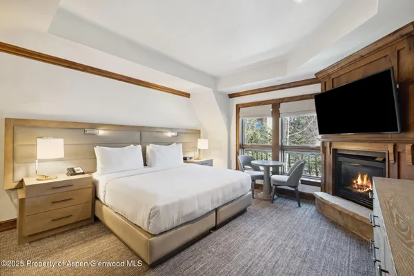 a bedroom with a bed and a fireplace
