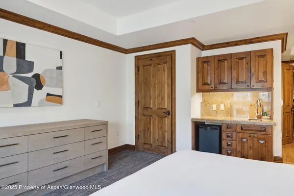 a bedroom with a bed and a dresser