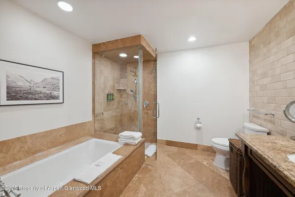 a spacious bathroom with a granite countertop tub sink and mirror