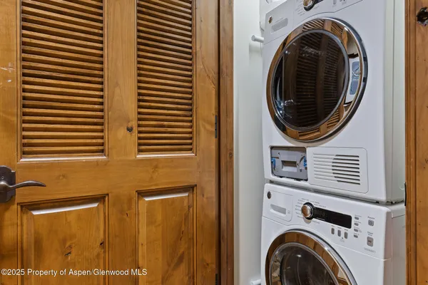 a view of a hallway with washer and dryer